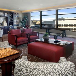 A modern living room with comfortable seating and large windows overlooking the city.