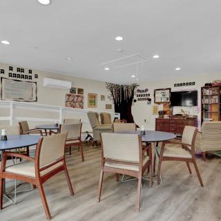 A cozy community dining area with tables and chairs, decorated with memorabilia.