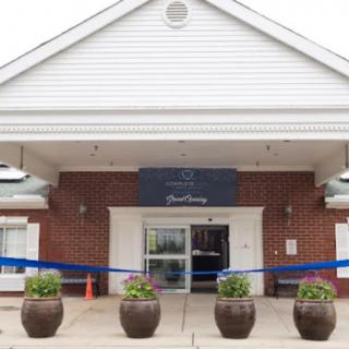 Entrance of a building prepared for a ribbon-cutting event.