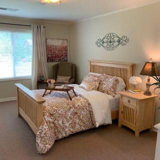 A cozy bedroom with wooden furniture and stylish decor.