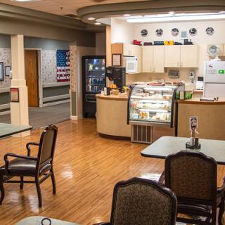 An indoor cafe with a seating area and a counter display.