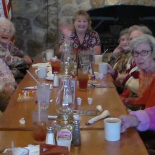 A group of seniors enjoying a meal together at a restaurant.