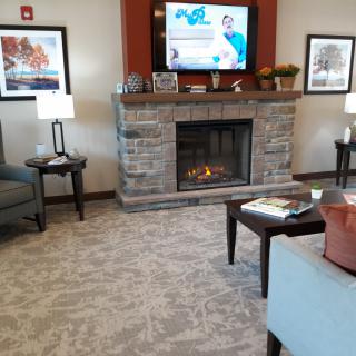 Cozy living room with a stone fireplace and comfortable seating.