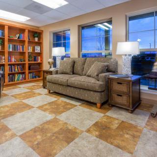 A cozy reading room with a comfortable sofa and shelves filled with books.