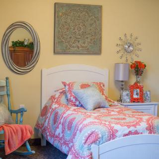 A cozy bedroom with floral bedding and stylish decor.