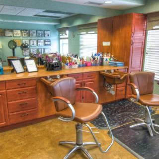 A well-organized hair salon with styling chairs and mirrors.