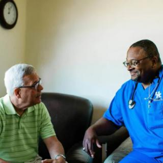 A doctor and a patient having a conversation in a medical setting.