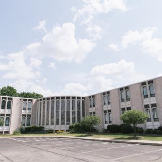 A mid-century modern building with large windows on a clear day.