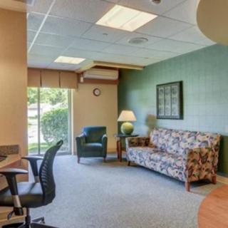 A cozy office waiting room with comfortable seating and natural light.