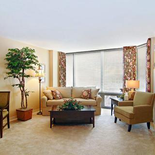 A cozy living room with comfortable seating and large windows.