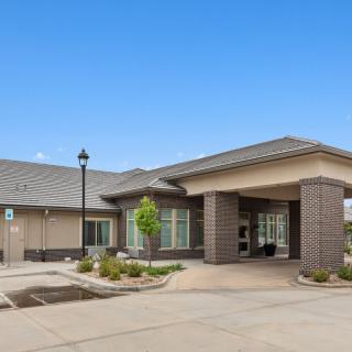 A modern facility with a welcoming entrance and landscaped surroundings.