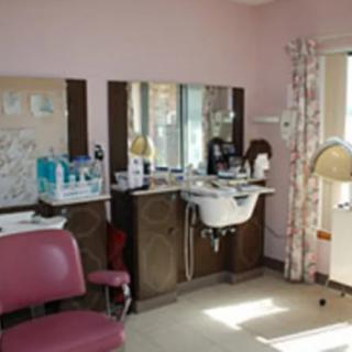 A cozy hair salon setup with chairs, mirrors, and hair washing stations.