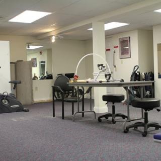 An open office space featuring workout equipment and a setup for activities.