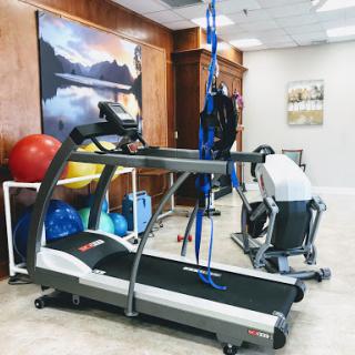A well-equipped fitness space featuring a treadmill and various training tools.