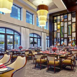 A modern and elegant restaurant interior with neatly arranged tables and chairs.
