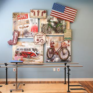 A vibrant display of vintage wall art featuring bicycles, retro signs, and the American flag, enhancing the character of the room.