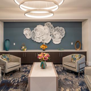 A modern lobby with elegant seating and decorative wall artwork.