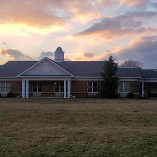 A serene house captured during a beautiful sunset.