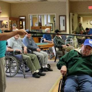Elderly individuals participate in a group activity at a nursing home.
