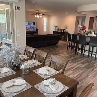 A spacious and modern open-concept living and dining area featuring elegant furniture and contemporary decor.