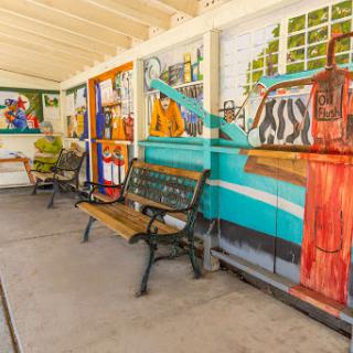 A vibrant community space featuring colorful murals and benches for relaxation.
