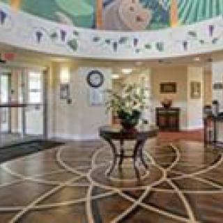 A beautifully decorated lobby entrance with a central table and floral arrangement.
