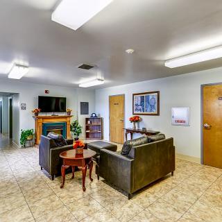 A cozy lobby area with sofas, a television, and decorative elements.