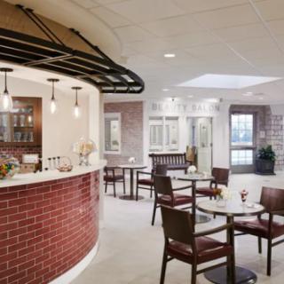 A modern cafe interior with a cozy seating area and bar.