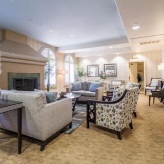 A cozy and elegantly designed living room with comfortable seating and a fireplace.