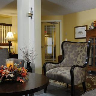 A cozy living room with elegant furniture and autumn-themed decor.