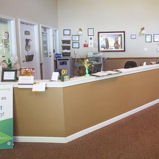 A reception area with a desk and office decorations.