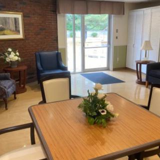 A cozy living space with comfortable seating and a central table adorned with a floral arrangement.