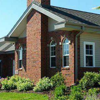 A charming brick house with a well-maintained garden.