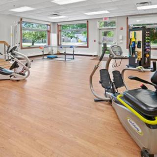 A modern gym equipped with various exercise machines and spacious workout areas.