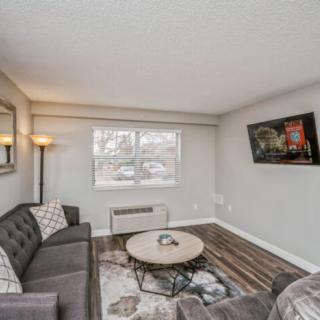 A cozy living room with modern furniture and decor.