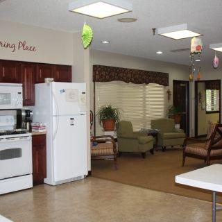 A cozy interior space featuring a kitchen and seating area.
