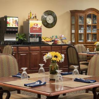 A cozy dining area with neatly arranged tables and a buffet station, perfect for casual meals.