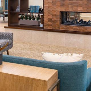 A modern living room featuring a cozy sofa and a stylish fireplace.