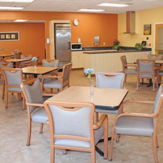 A cozy dining area featuring modern furniture and a warm color palette.