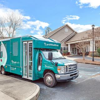 A turquoise mobile unit parked outside a residential building, ready to provide services.