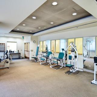 A well-equipped gym featuring various exercise machines for strength training.