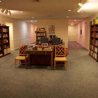 Cozy library interior with bookshelves and a reading area.