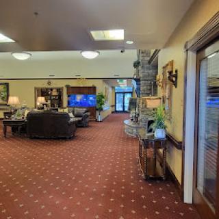 A cozy lobby space with comfortable seating and a television, designed for relaxation and socializing.