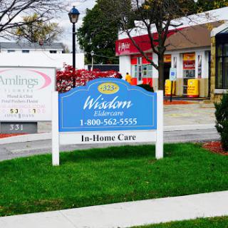 A sign for Wisdom In-Home Care, promoting healthcare services.