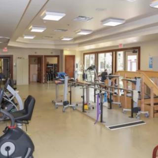 A well-equipped gym featuring various exercise machines and rehabilitation equipment.