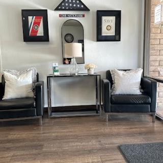 A stylish seating area featuring contemporary furniture and decorative wall art.