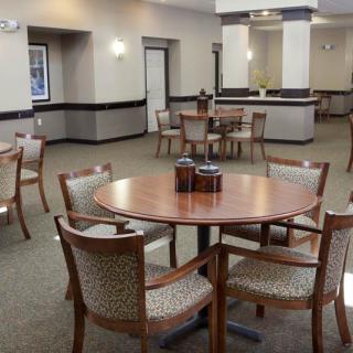 A spacious dining area with several tables and chairs arranged for gatherings.