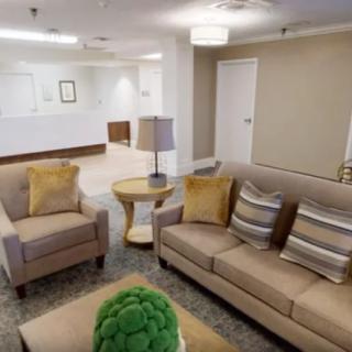 A modern lobby with comfortable seating, stylish decor, and a reception area.