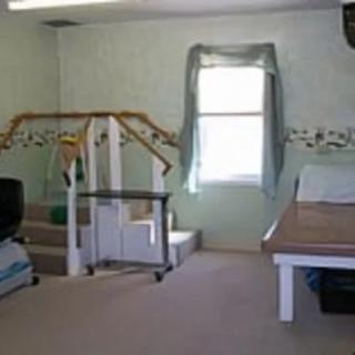 A therapy room with exercise equipment and stairs for rehabilitation exercises.