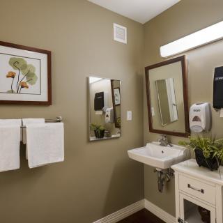 A well-organized bathroom with a sink, mirror, and decor.